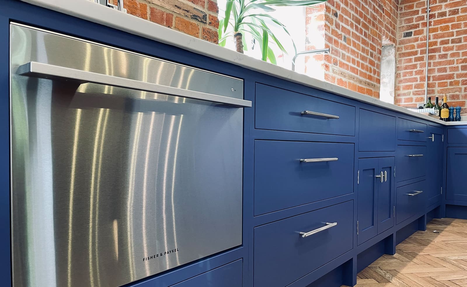 Open plan bespoke kitchen and lounge by Rao Furniture